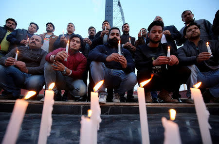 People light candles during a vigil held for the army officers who were killed in an attack earlier this morning at an army camp, in Jammu, February 10, 2018. REUTERS/Mukesh Gupta