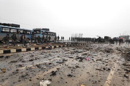 Indian soldiers examine the debris after an explosion in Lethpora in south Kashmir's Pulwama district February 14, 2019. REUTERS/Younis Khaliq