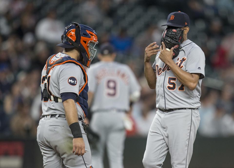 Tigers catcher Alex Avila and relief pitcher Francisco Rodriguez meet at the pitcher's mound during the seventh inning of the Tigers' 9-6 loss Thursday in Seattle.