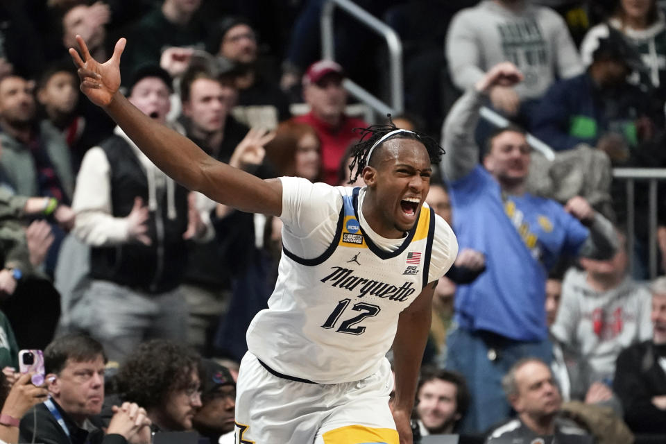 Marquette forward Olivier-Maxence Prosper (12) reacts after hitting a three-point basket against Michigan State in the first half of a second-round men's college basketball game in the NCAA Tournament Sunday, March 19, 2023, in Columbus, Ohio. (AP Photo/Paul Sancya)