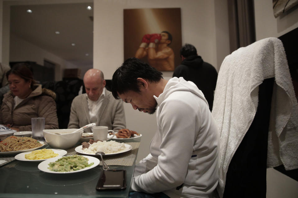 FILE - In this Jan. 14, 2019, file photo, boxer Manny Pacquiao prays before breakfast at his home following his morning run in Los Angeles. A spokesman for Pacquiao says the famed fighter's Los Angeles home was robbed at about the time he was in the ring with rival Adrien Broner in Las Vegas. Spokesman Mike Quinn confirmed the burglary to NBC News. Los Angeles police said a burglary was reported about 4:15 p.m. Sunday, Jan. 20, 2019. in the Larchmont neighborhood. (AP Photo/Jae C. Hong, File)