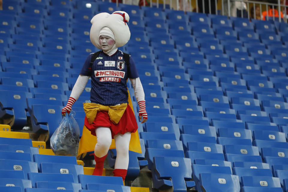 <p>A fan of Japan collects trash after the round of 16 match between Belgium and Japan at the 2018 soccer World Cup in the Rostov Arena, in Rostov-on-Don, Russia, Monday, July 2, 2018. (AP Photo/Pavel Golovkin) </p>