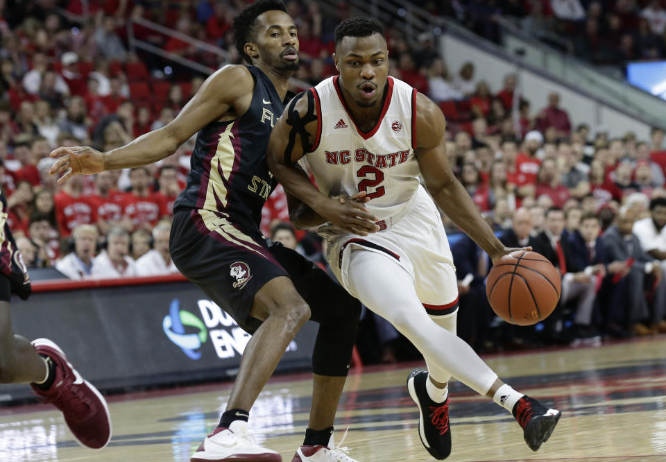 Florida State’s Braian Angola guards North Carolina State’s Torin Dorn (2) during the first half of an NCAA college basketball game in Raleigh, N.C., Sunday, Feb. 25, 2018. (AP Photo/Gerry Broome)