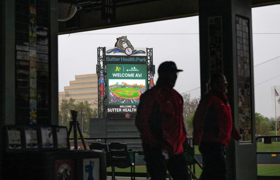 The Sutter Health Park scoreboard welcomes the Oakland Athletics as park staff members walk past on Thursday, April 4, 2024, after the announcement that the A’s will relocate to West Sacramento in 2025 and play there for at least three seasons.