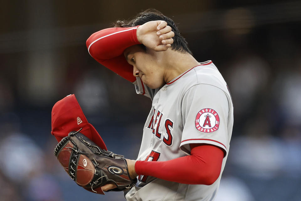 Los Angeles Angels pitcher Shohei Ohtani wipes his brow during the first inning of the team's baseball game against the New York Yankees on Wednesday, June 30, 2021, in New York. (AP Photo/Adam Hunger)