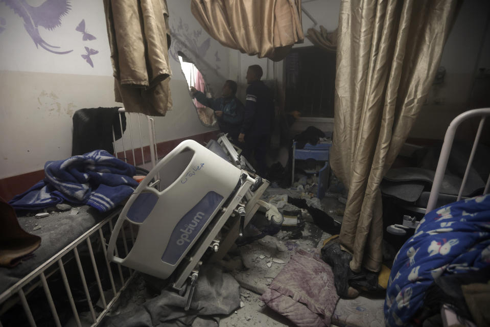Palestinian paramedics inspect damage in the patient rooms caused by the Israeli strikes on the maternity ward at Nasser Hospital in the town of Khan Younis, southern Gaza Strip, Sunday, Dec. 17, 2023. (AP Photo/Mohammed Dahman)