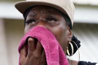 Rakisha Murray cries in relief as she arrives to see her mother's home undamaged, after she returned from evacuation with her mother and other family in Lake Charles, La., in the aftermath of Hurricane Laura, Sunday, Aug. 30, 2020. (AP Photo/Gerald Herbert)