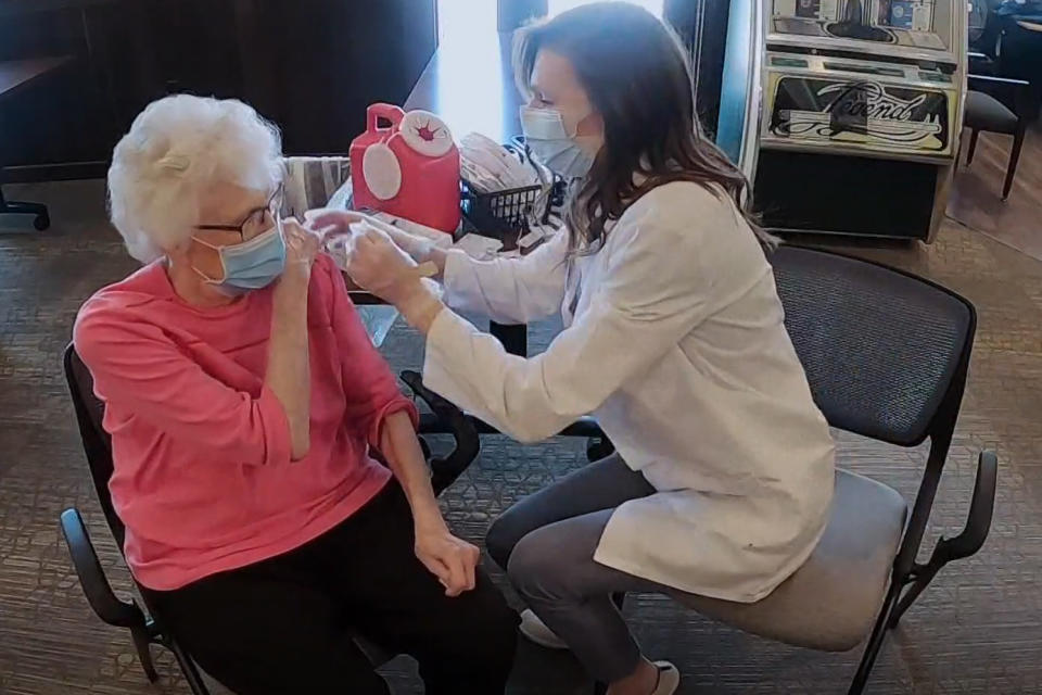 Image: Lindsay Hawkins gives her grandmother Glenna Luetgers her second Covid-19 vaccine in Plymouth, Minn. (KARE11)