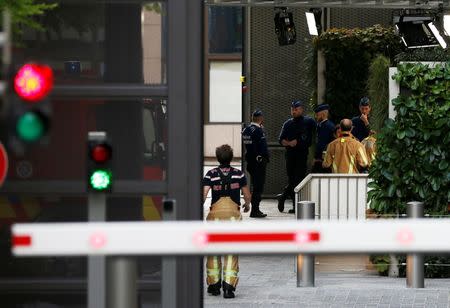 Emergency services personnel are seen at the entrance of the European Union Council building after noxious gases were found in its kitchens in Brussels, Belgium October 13, 2017. REUTERS/Francois Lenoir
