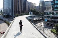 An anti-government protester walks on top of an elevated walkway outside the Polytechnic University in Hong Kong