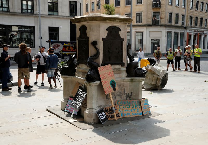 FILE PHOTO: People observe the base of the statue of Edward Colston