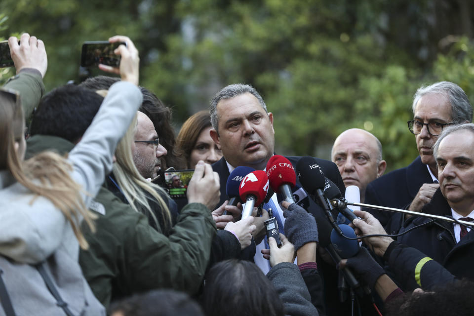 Greek Defense Minister Panos Kammenos, center, makes a statement to the media following a meeting with Greece's Prime Minister Alexis Tsipras, in Athens, Sunday, Jan. 13, 2019. Greek defense Minister Kammenos, leader of the right-wing populist Independent Greeks party, is vehemently opposed to a deal with neighboring Macedonia over its state name. (AP Photo/Yorgos Karahalis)