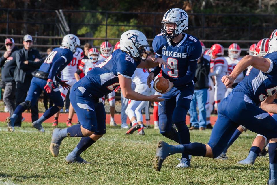 Laker quarterback John Mahan III hands off to Vincent Olivieri who gets a short yardage gain on a running play.