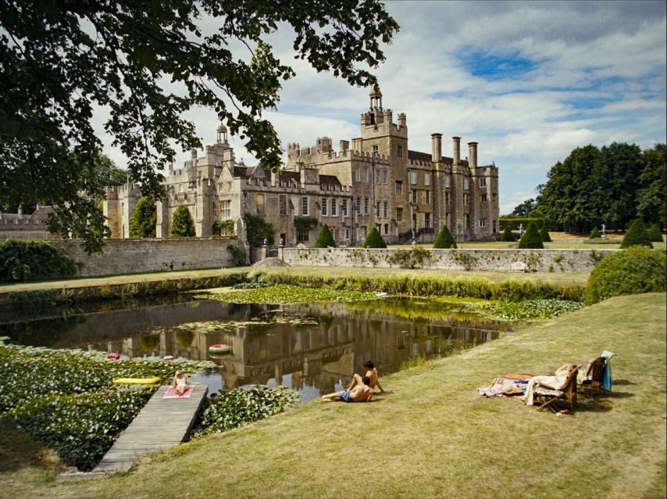 a large building with a pond in front of it