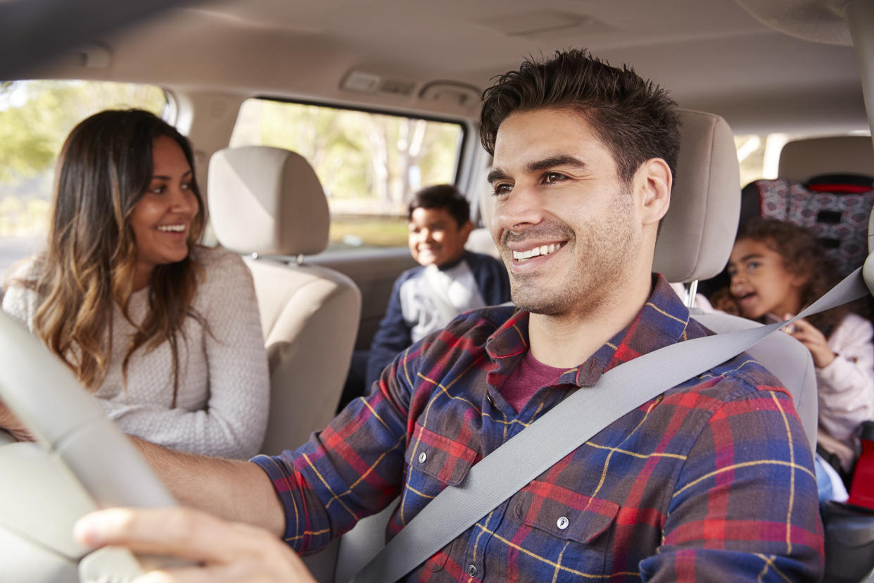 Mother turns around to her children on the back seat of car