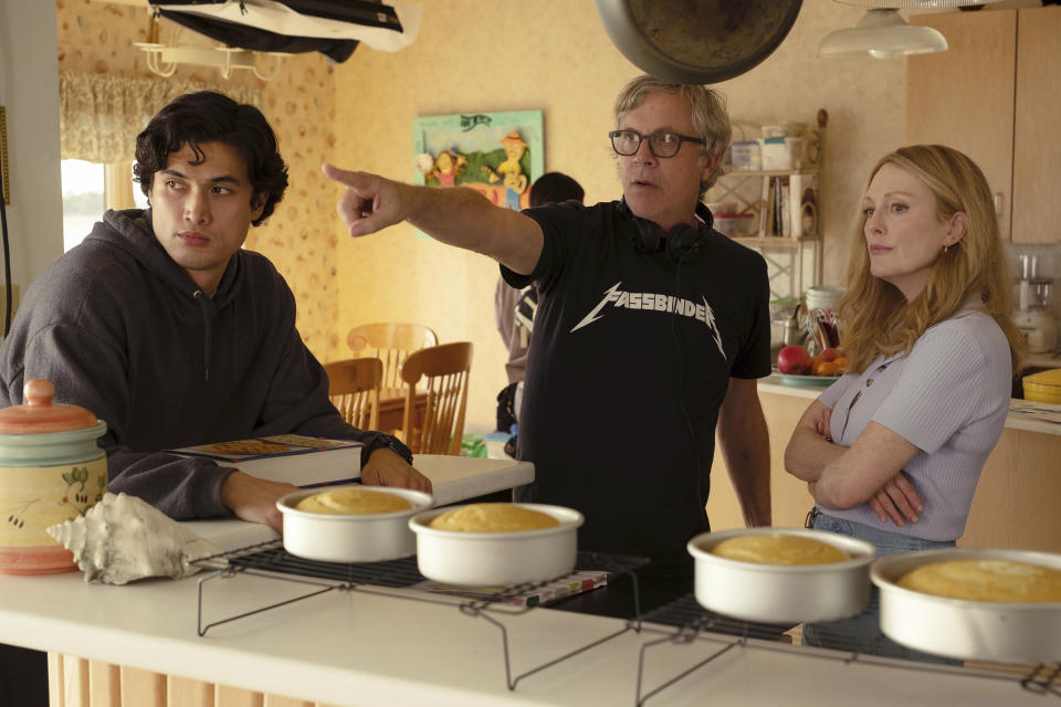 This image released by Netflix shows actor Charles Melton, from left, filmmaker Todd Haynes and actor Julianne Moore on the set of "May December." (François Duhamel, Netflix via AP)