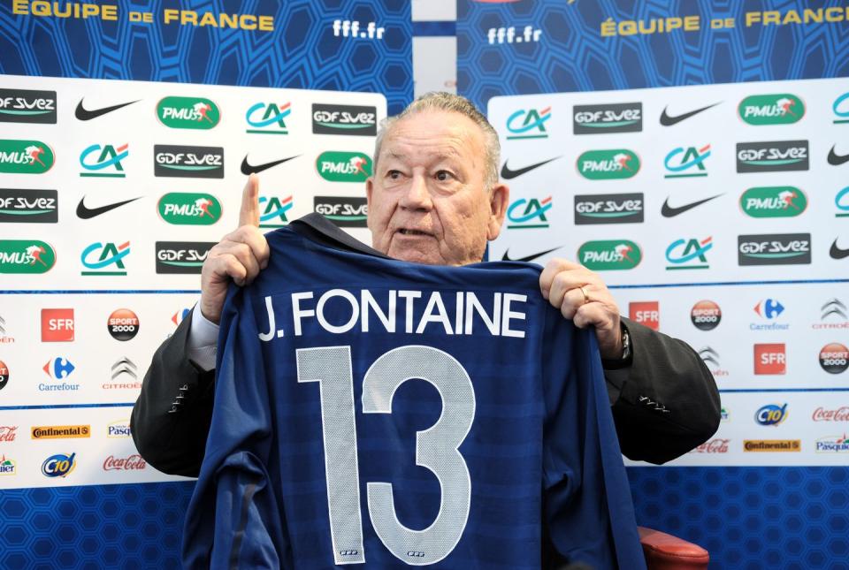 france soccer player just fontaine holds up one of his jerseys