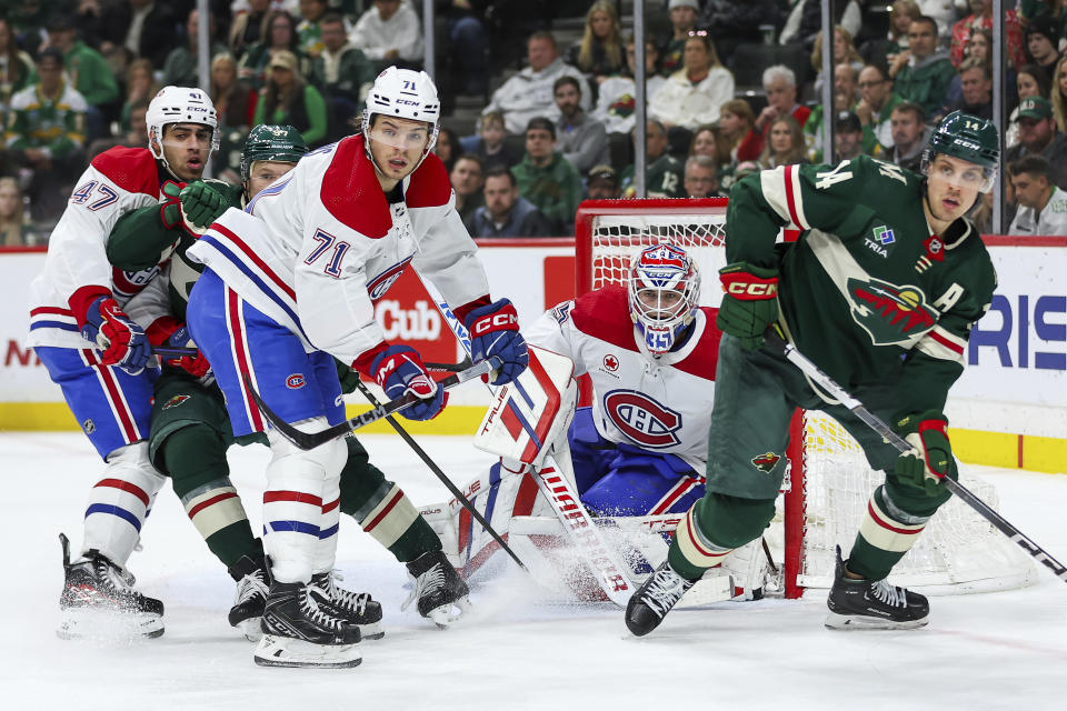 Montreal Canadiens goaltender Sam Montembeault (35) defends his net while Canadiens defenseman Jayden Struble (47), Canadiens center Jake Evans (71), Minnesota Wild left wing Kirill Kaprizov (97) and Wild center Joel Eriksson Ek (14) compete for position during the second period of an NHL hockey game Thursday, Dec. 21, 2023, in St Paul, Minn. (AP Photo/Matt Krohn)