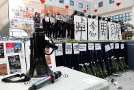 Students attend a ceremony to pay tribute to Chow Tsz-lok, 22, a university student who fell during protests at the weekend and died early on Friday morning, at the Hong Kong University of Science and Technology