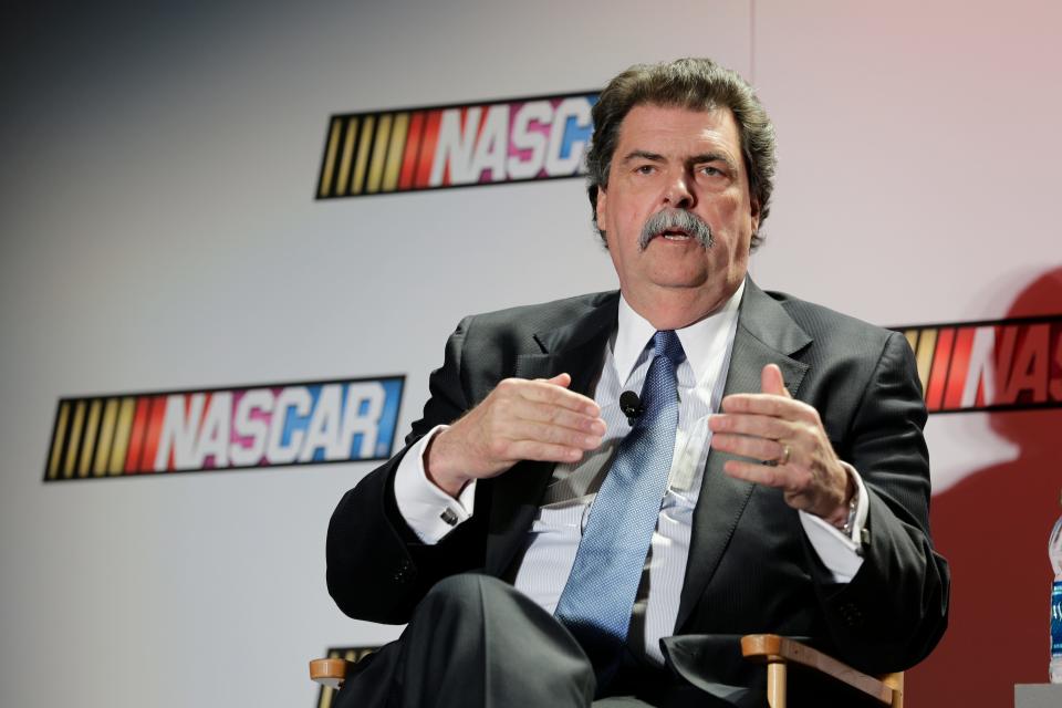 FILE - NASCAR president Mike Helton talks to the media during a news conference at the NASCAR Sprint Cup auto racing Media Tour in Charlotte, N.C., on Jan. 30, 2014. Helton was named the Landmark Award winner for outstanding contributions to the sport Wednesday, May 4, 2022, during a ceremony at the NASCAR Hall of Fame. (AP Photo/File)