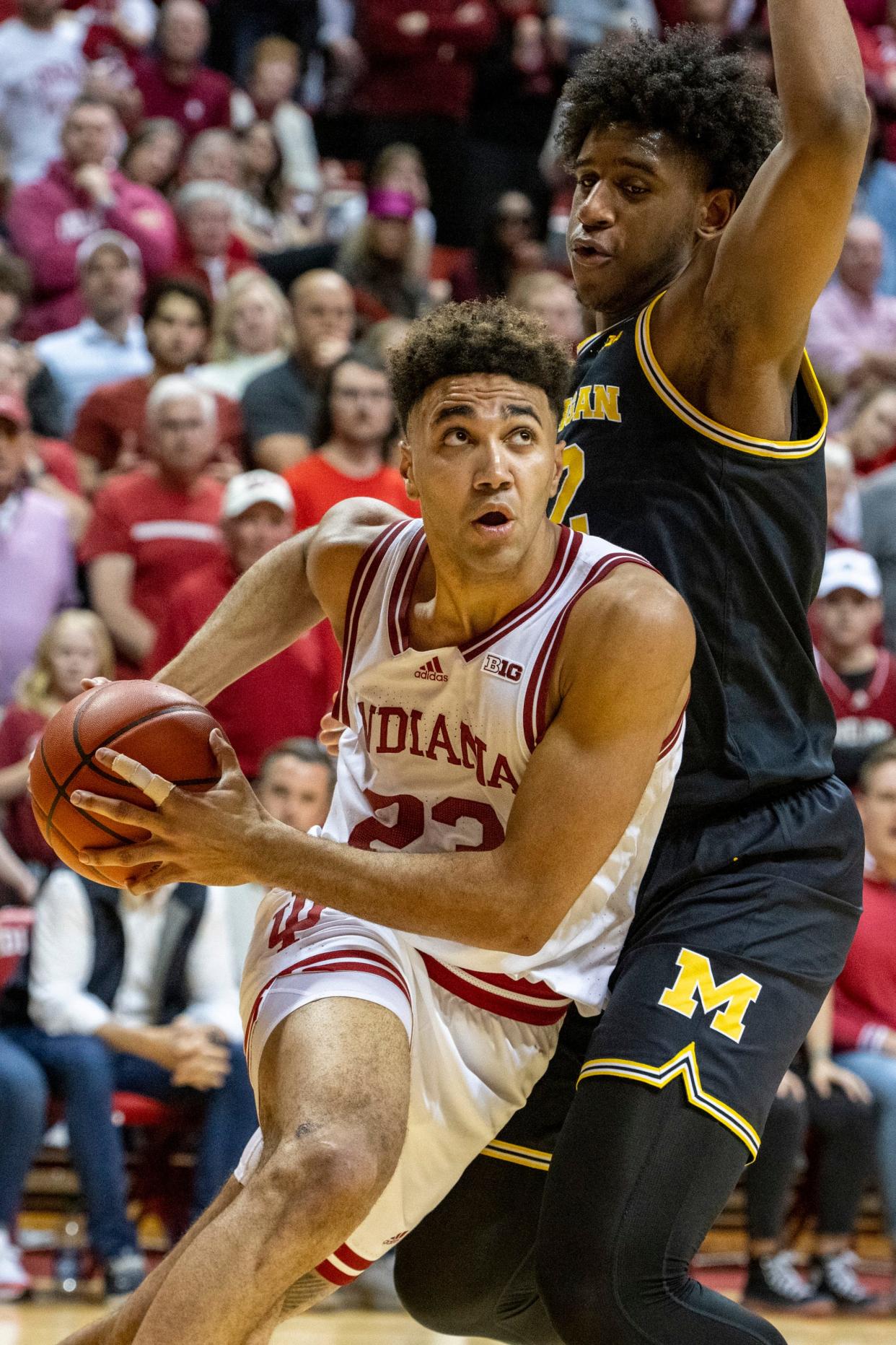 Indiana forward Trayce Jackson-Davis drives the baseline while being defended by Michigan forward Tarris Reed Jr. in overtime, Sunday, March 5, 2023, in Bloomington, Ind.