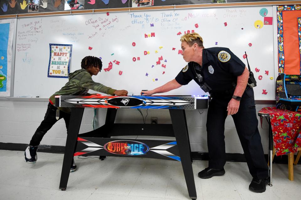 School Resource Officer Faye Okert plays air hockey with a student at Stratton Elementary School in Madison, Tenn. on Wednesday, May 25, 2022.