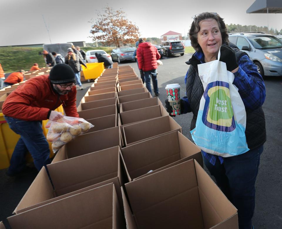 Tammy Joslyn, executive director of Operation Blessing, talks about the contents of each Thanksgiving basket going out to needy families with the help of many volunteers in Portsmouth Monday, Nov. 21, 2022.