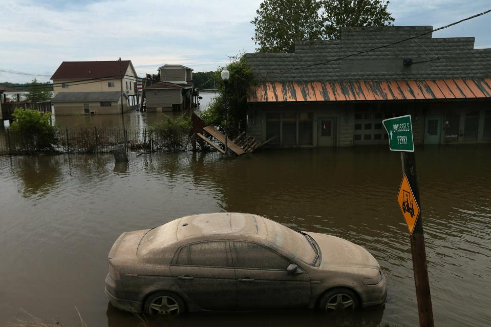 A lone car, once submerged in flood waters, sits caked in mud along Main Street on Wednesday, June 19, 2019, in Grafton, Ill. On Wednesday, the level of the Mississippi River was 30.2 feet, having dropped about five feet from its crest at 35.17 on June 7.  (Photo: Laurie Skrivan/St. Louis Post-Dispatch via AP)