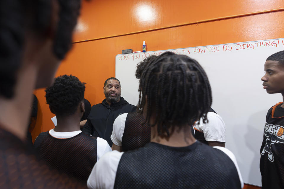 Book Richardson, director of the New York Gauchos boy's basketball program, speaks with his players in the locker room at the Gaucho Gym, Monday, March 11, 2024, in the Bronx borough of New York. (AP Photo/Peter K. Afriyie)