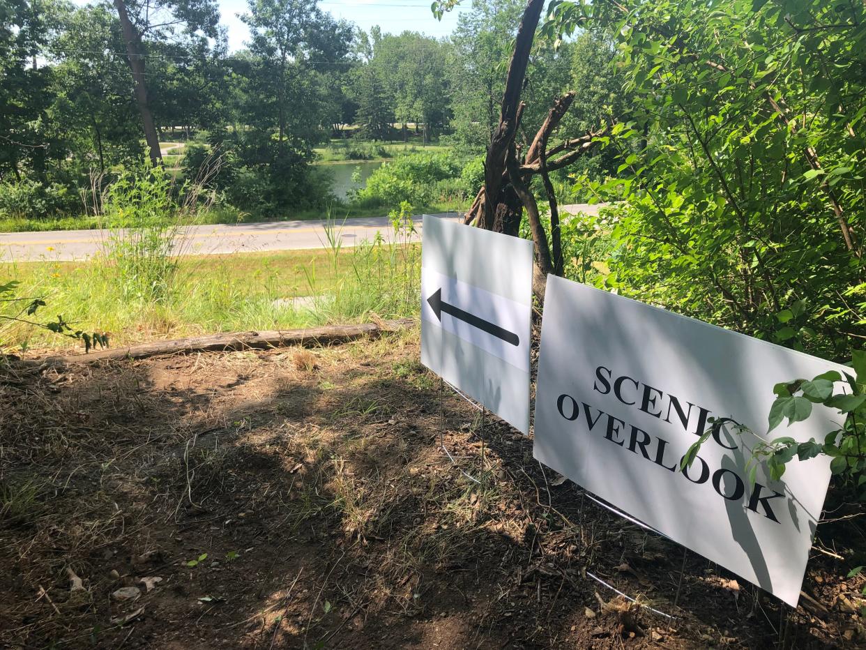 A sign points to an overlook of South Bend's Pinhook Park, seen from the freshly cut preliminary trails at the Portage Manor property in South Bend during an open house for trails on June 15, 2024.