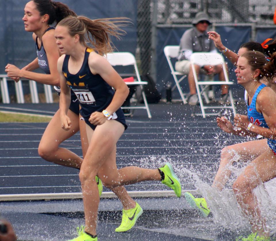 Angelina Ellis (162) of Butler and Ceili McCabe (1711) of West Virginia lead over the water jump, pursued by Kristel van den Berg of Ole Miss, in the women's 3,000-meter steeplechase  during the NCAA East Preliminary track and field meet at the University of North Florida in Jacksonville on May 27, 2023. [Clayton Freeman/Florida Times-Union]