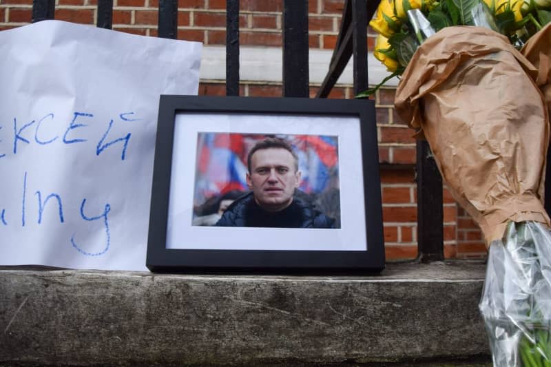 Flowers are left next to a picture of leading Russian opposition leader Alexei Navalny, outside the Russian Embassy in London, after he was announced dead in prison in Russia. Leading Russian opposition figure Alexei Navalny has died in prison on Friday at the age of 47. Vuk Valcic/ZUMA Press Wire/dpa