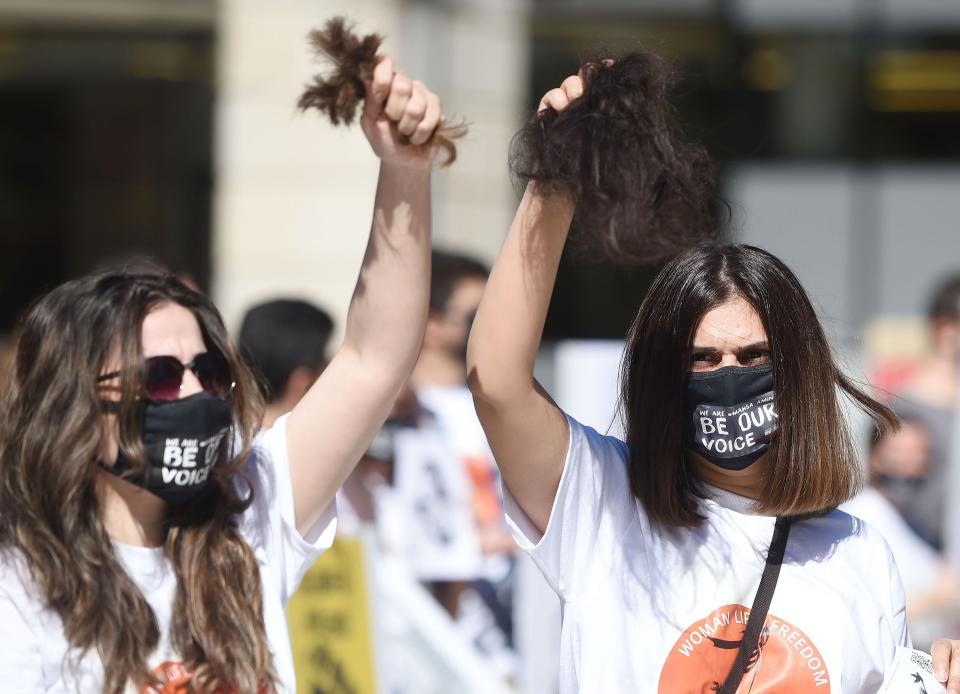 Iranian students at Iowa State University protest against the Iranian government for brutality against women in front of the university Parks Library on Thursday in Ames. The students gathered after Mahsa Amini, a 22-year-old Iranian woman, was killed last week by the Iranian “morality police” for not fully covering her hair.