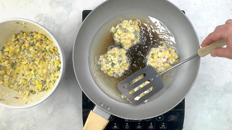 flattening corn and jalapeño fritters