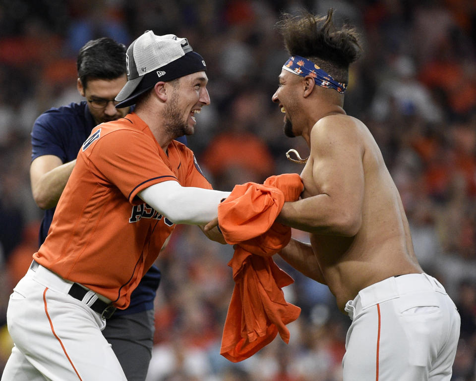 Houston Astros' Alex Bregman, left, and Yuli Gurriel celebrate their clinching of the AL West crown after a baseball game against the Los Angeles Angels, Sunday, Sept. 22, 2019, in Houston. (AP Photo/Eric Christian Smith)