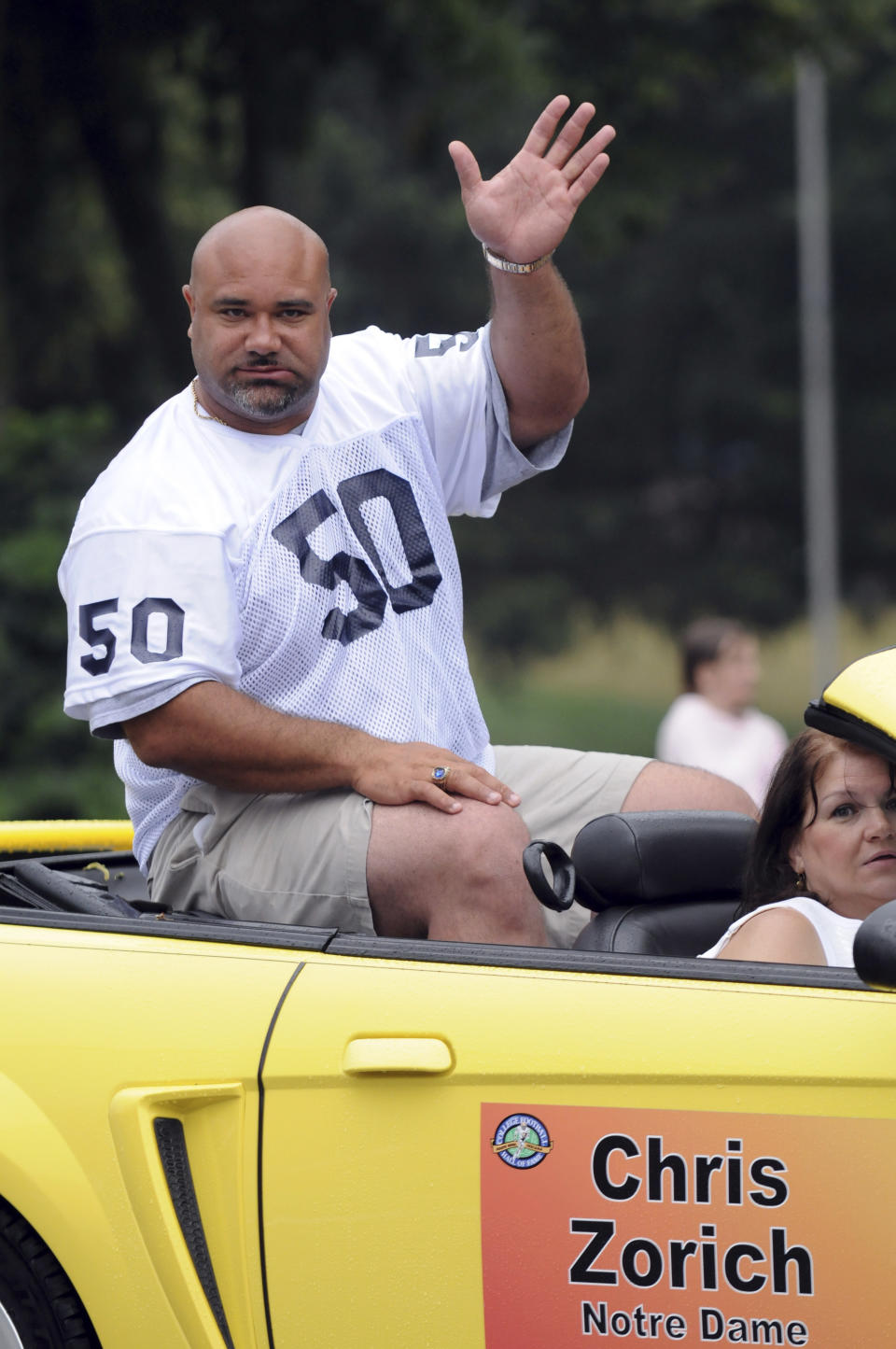 FILE - Chris Zorich, defensive tackle for Notre Dame 1988-90, and former Chicago Bears player, waves to the crowd during the College Football Hall of Fame Enshrinement parade in South Bend, Ind., in this Saturday, July 19, 2008, file photo. Dozens of Chicago natives have played for Notre Dame and a few have come home to play for the NFL's Chicago Bears. (AP Photo/Joe Raymond, File)