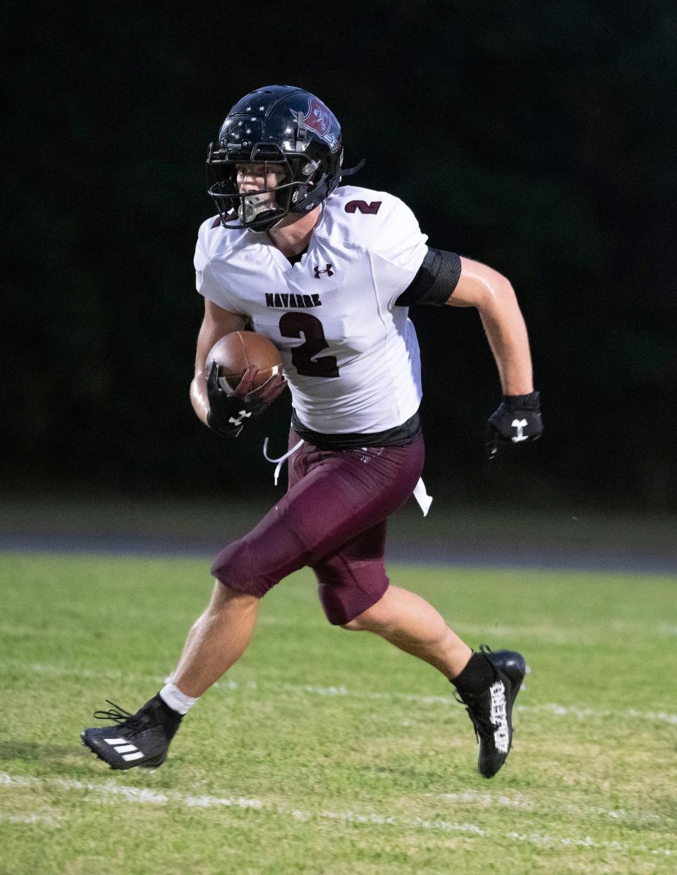 Navarre's Connor Black (No. 2) finds open field and runs for extra yards against the Pine Forest defense on Friday, September 1, 2023.