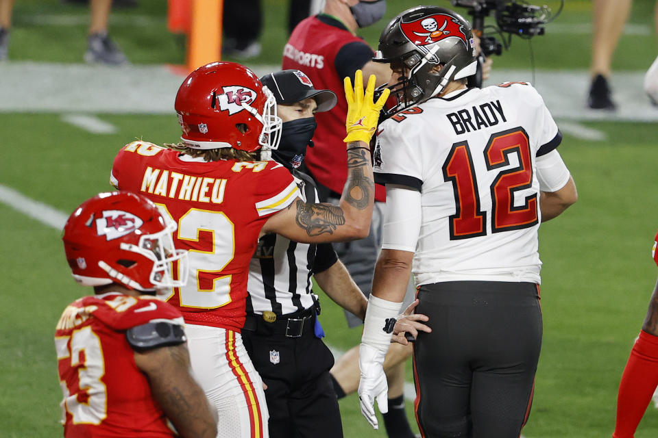 Feb 7, 2020; Tampa, FL, USA; An NFL official moves in to separate Tampa Bay Buccaneers quarterback Tom Brady (12) and Kansas City Chiefs strong safety Tyrann Mathieu (32) during the second quarter of Super Bowl LV at Raymond James Stadium.  Mandatory Credit: Kim Klement-USA TODAY Sports