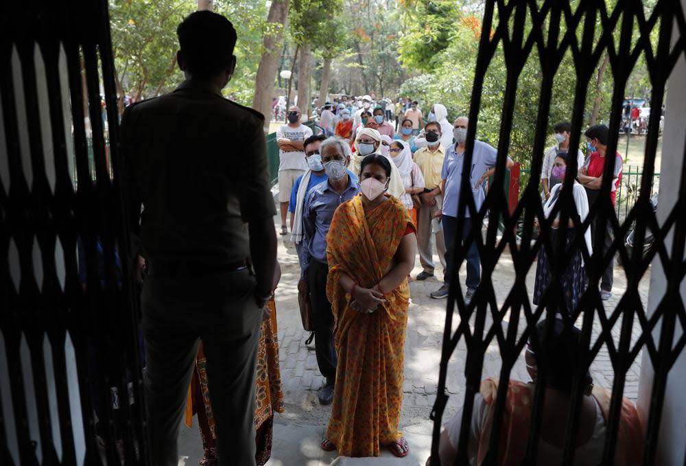 Indians line up to receive the vaccine for COVID-19 at a medical college in Prayagraj, India, Saturday, May 8, 2021. Two southern states in India became the latest to declare lockdowns, as coronavirus cases surge at breakneck speed across the country and pressure mounts on Prime Minister Narendra Modi’s government to implement a nationwide shutdown. (AP Photo/Rajesh Kumar Singh)