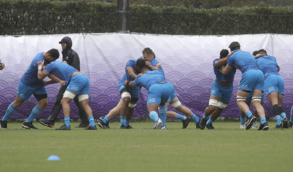 New Zealand players stretch during a training session in Tokyo, Japan, Tuesday, Oct. 22, 2019. The All Blacks play England in a Rugby World Cup semifinal in Yokohama on Saturday Oct. 26. (AP Photo/Mark Baker)