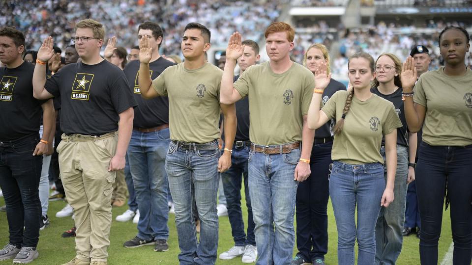 Military recruits are sworn in during halftime on Salute to Service military appreciation day at an NFL football game between the Jacksonville Jaguars and the Las Vegas Raiders, Sunday, Nov. 6, 2022, in Jacksonville, Fla. (AP Photo/Phelan M. Ebenhack)
