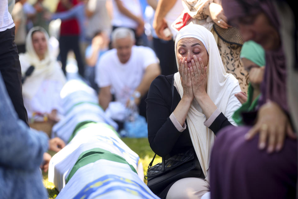 A Bosnian muslim woman mourns next to the coffin of her relative, newly identified victim of the Srebrenica genocide, at the Srebrenica Memorial Centre, in Potocari, Bosnia, Thursday, July 11, 2024. Thousands gather in the eastern Bosnian town of Srebrenica to commemorate the 29th anniversary on Monday of Europe's only acknowledged genocide since World War II. (AP Photo/Armin Durgut)