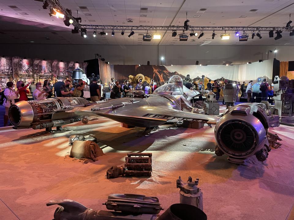 At the centre of the exhibition was a life-size N1 Naboo Starfighter with a small animatronic of Grogu (also known by fans as Baby Yoda) waving from inside (Mike Bedigan/PA)