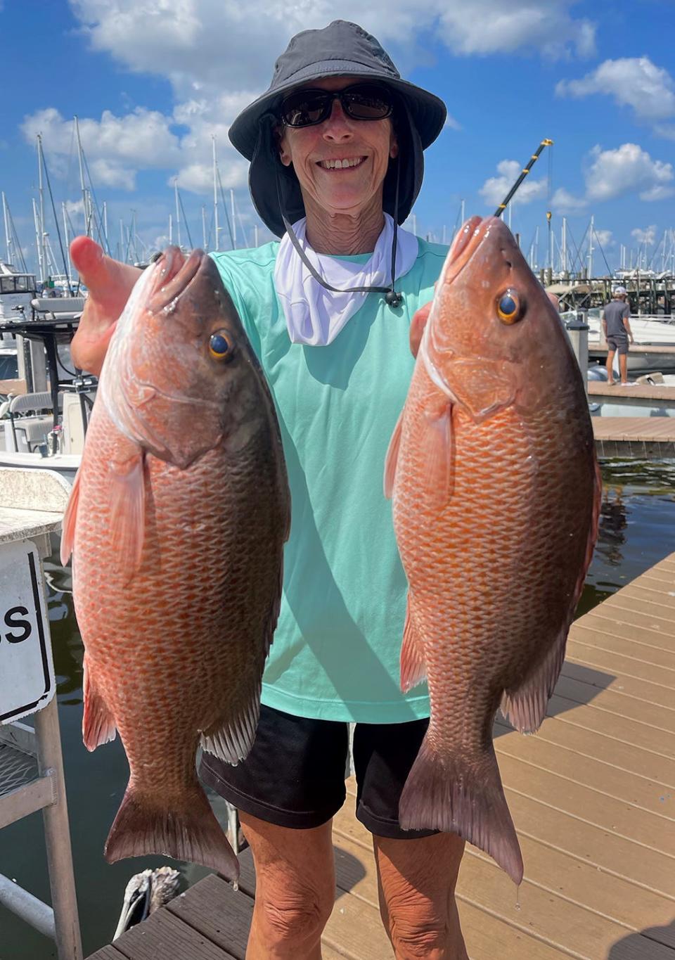 Jean Corbin of Englewood, caught these twin 20-inch mangrove snapper on live pinfish while fishing in lower Tampa Bay with Capt. John Gunter recently.