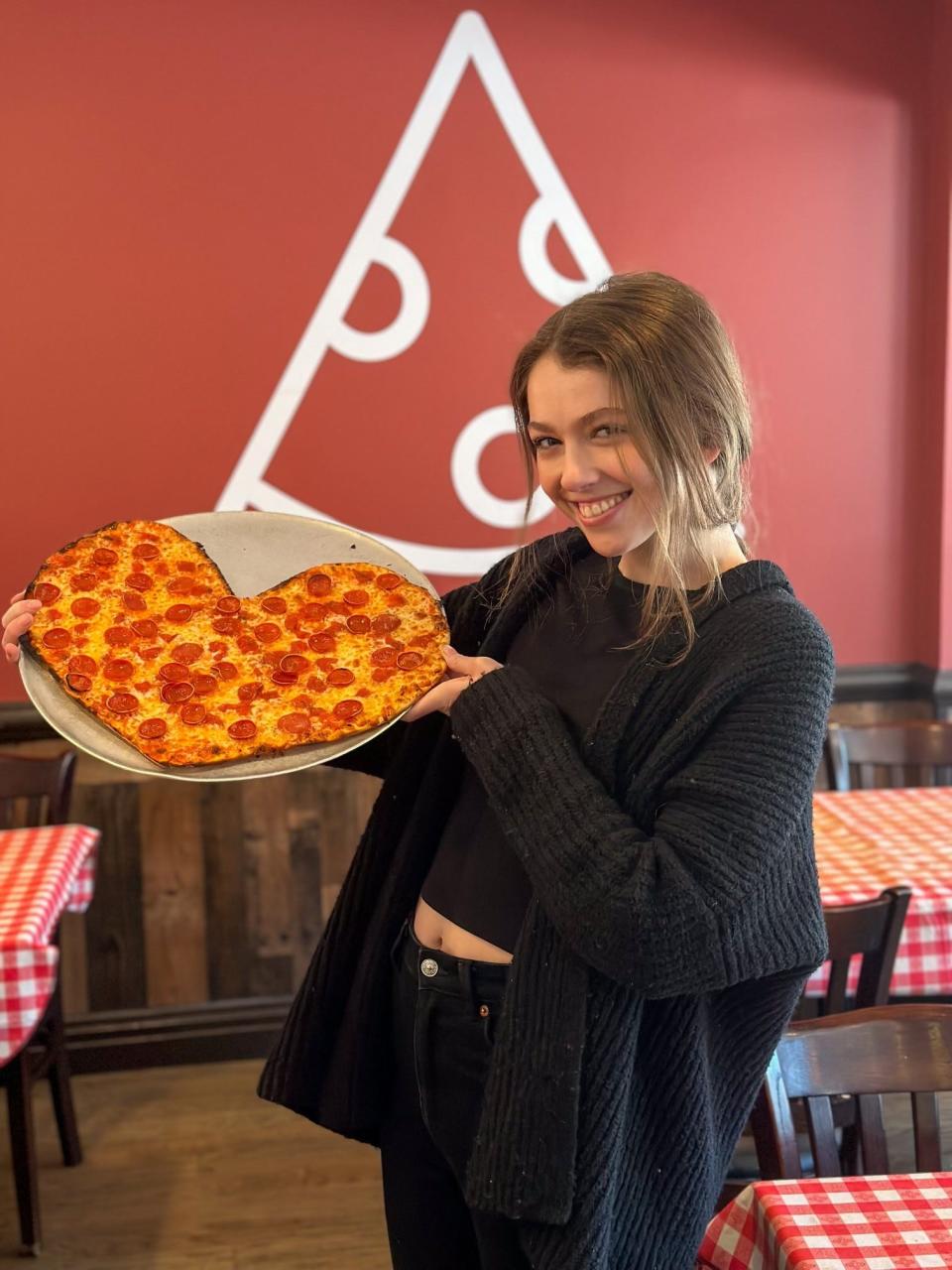 Mairead Murtha, one of the bartenders at The Pie Man in Valley Cottage, shows off their thin crust heart-shaped pepperoni pie for Valentine's Day.