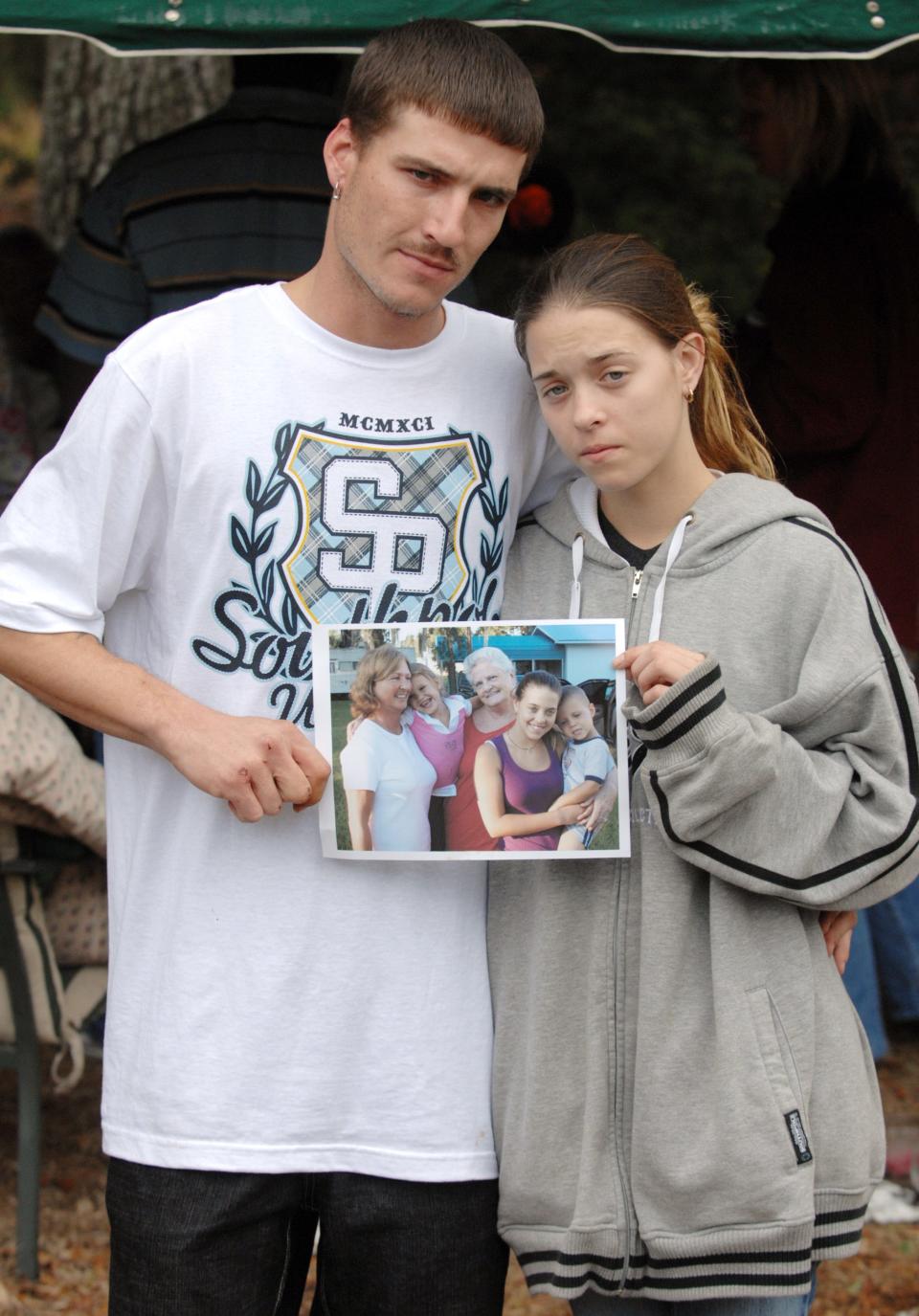 Feb. 12, 2009: Ronald Cummings with his girlfriend Misty Croslin with a family photo from better times during day three in the search for Haleigh.