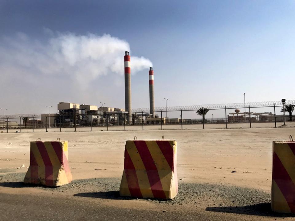 Vehicle barriers in front of the twin smokestacks of the the Jidda South Thermal Power Plant.