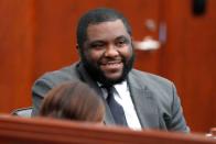 Chief Public Defender Deonte’ L. Thomas smiles while talking with Kailey Morgan, an intern from North Carolina Prisoner Legal Services, before the start of the day’s proceedings in the trial of Kendrick Gregory at the Wake County Justice Center in Raleigh, N.C., Wednesday, July 28, 2021.