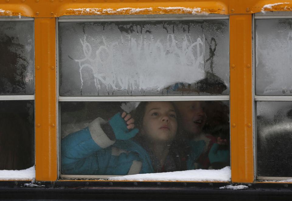 Children arrive on a bus to take a tour of the Frank E. Moss federal courthouse in Salt Lake City