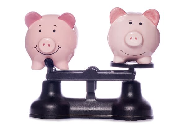 Two piggy banks on scales